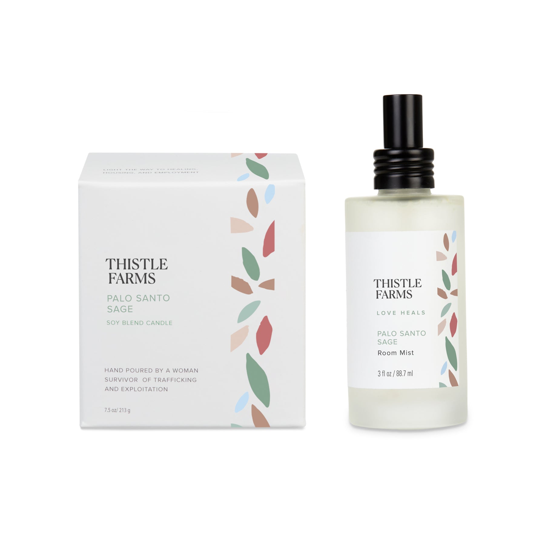 The decorated box for the Palo Santo Sage candle sits to the left of the frosted spray bottle for the Palo Santo Sage Room Mist. Each label has green, brown, red and light blue petals to represent the scent of Palo Santo Sage.