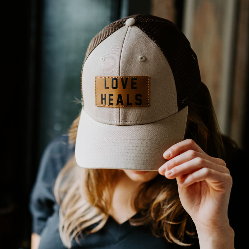Love Heals Tan Trucker Hat