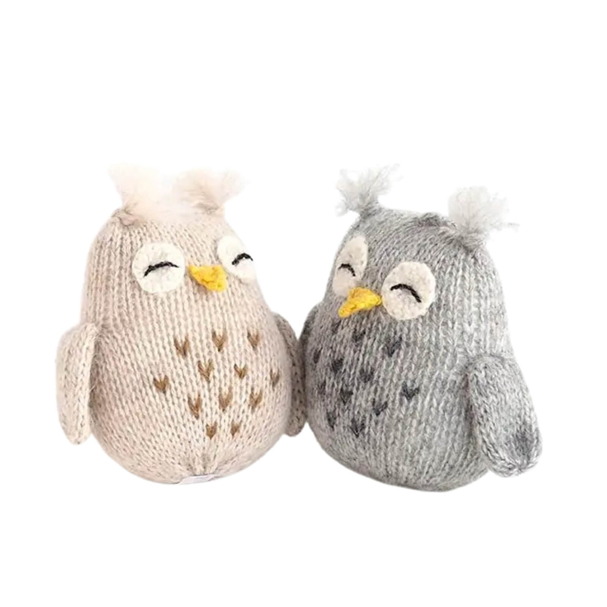 Two knitted owl toys, one beige and one gray, on a white background