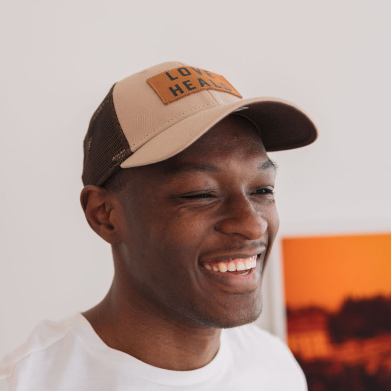 Love Heals Tan Trucker Hat