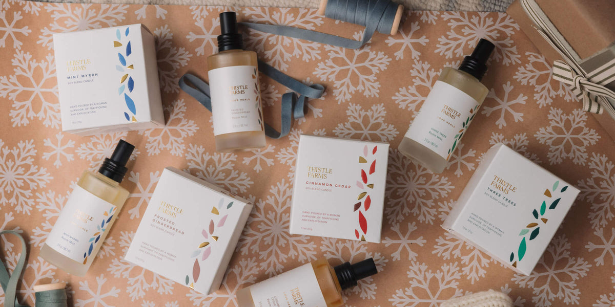 Room mists and candles on a decorative surface with floral patterns