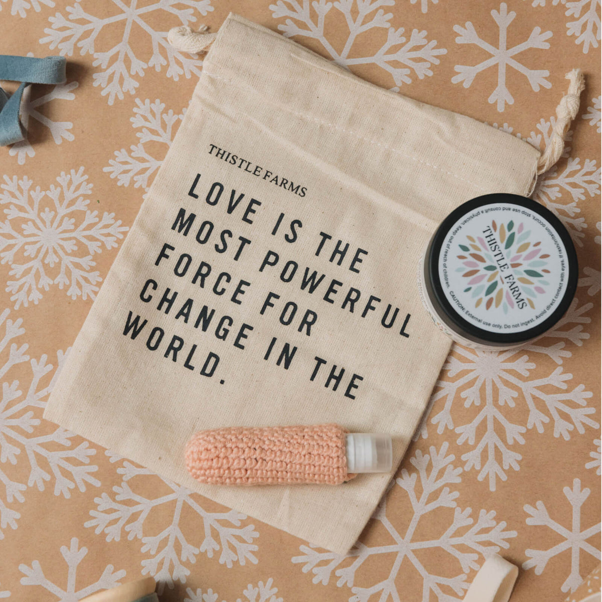 Product packaging with 'Thistle Farms' branding and motivational quote on a patterned background
