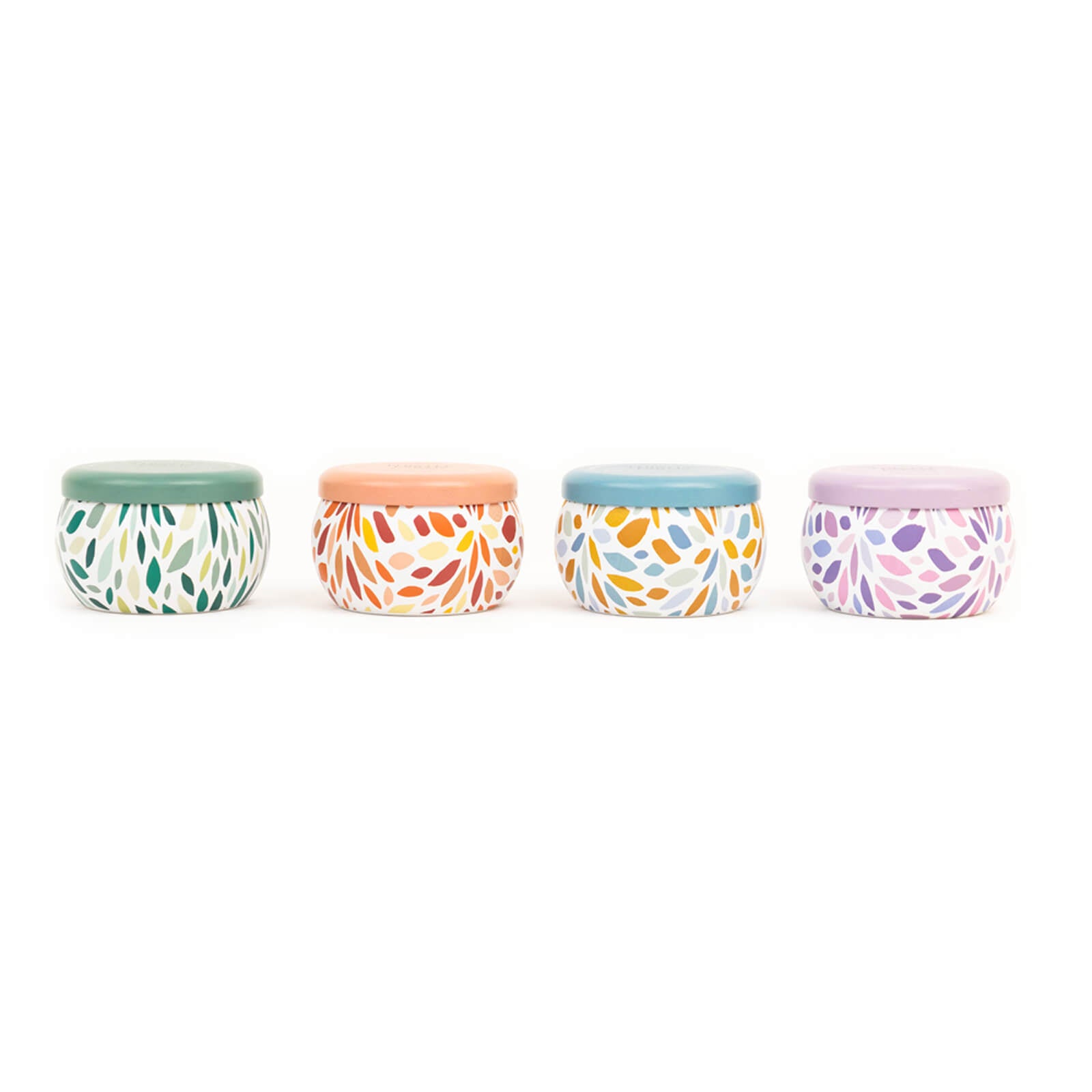 Four small containers with colorful patterns and lids on a white background