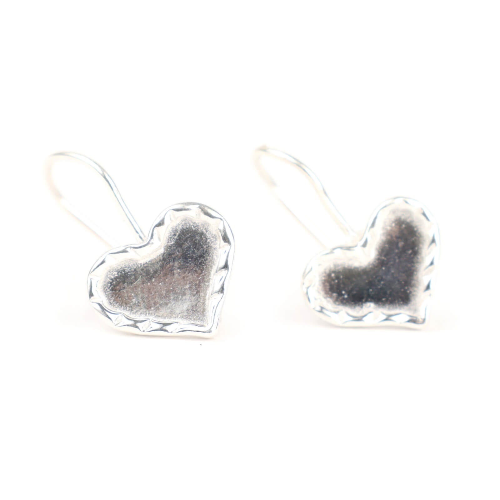 Heart-shaped silver earrings on a white background