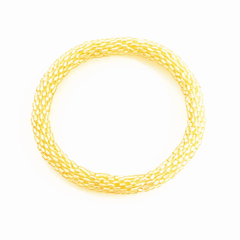 Gold beaded bracelet on a white background