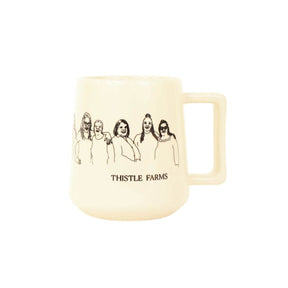 Beige mug with black illustrations and 'Thistle Farms' text on a white background