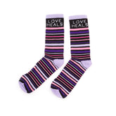 Pair of striped socks with 'Love Heals' text on a white background