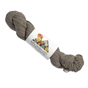 Brown skein of yarn with a label saying 'lofty peaks yarn' on a white background