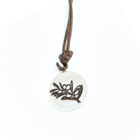 Necklace with a round pendant featuring a olive branch design on a white background