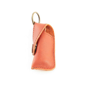 Orange leather keychain case on a white background
