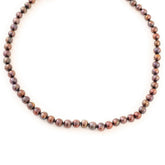 Pearl necklace with a gold clasp on a white background