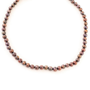 Pearl necklace with a gold clasp on a white background