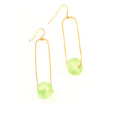 Gold earrings with green beads on a white background