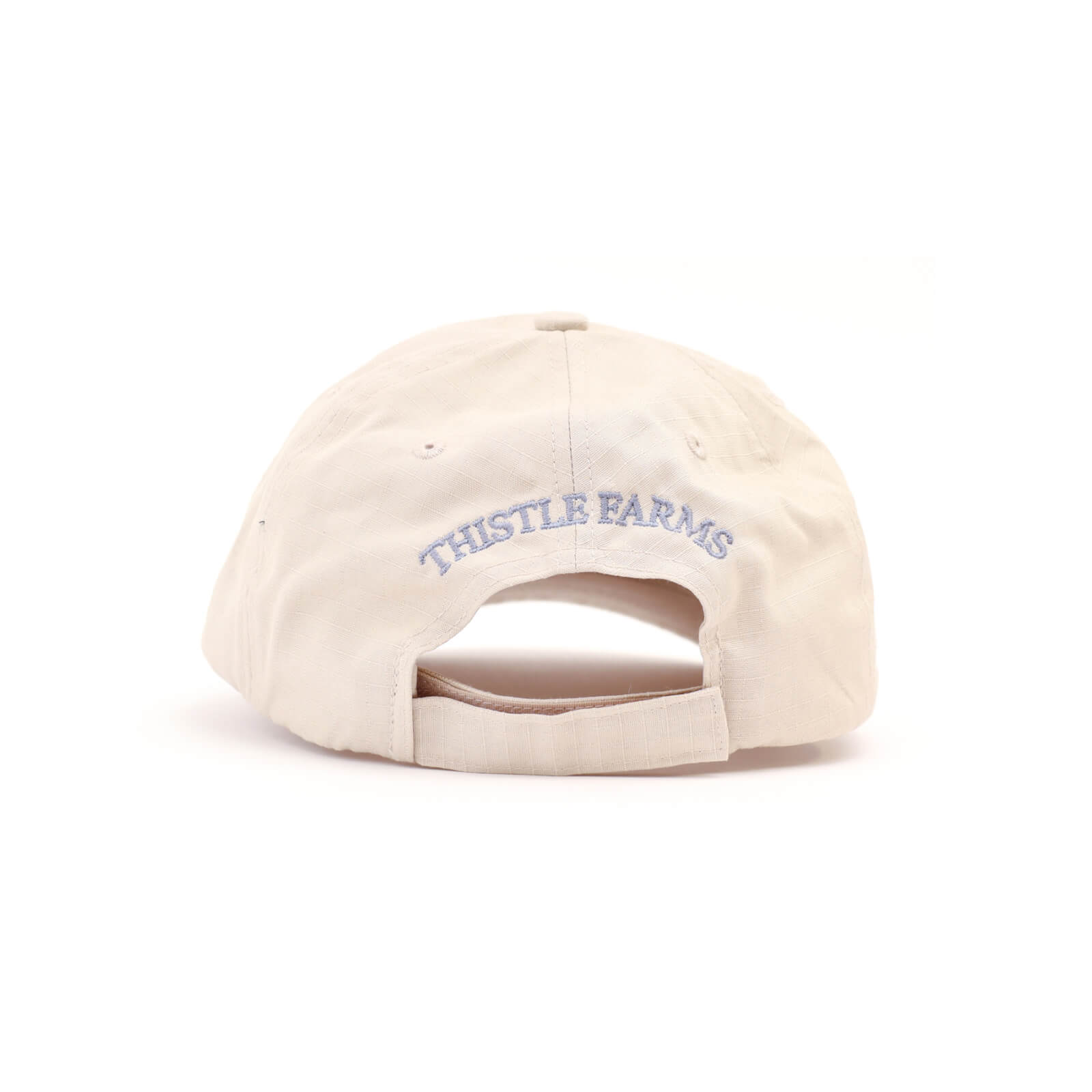 Beige cap with 'Thistle Farms' logo on a white background