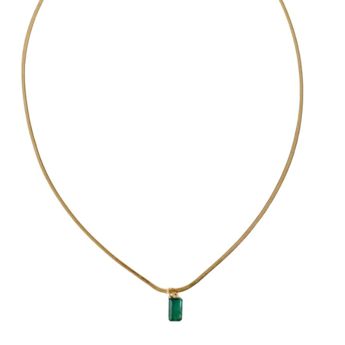 Necklace with a green pendant on a thin gold chain against a white background