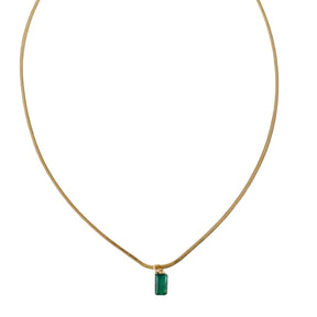 Necklace with a green pendant on a thin gold chain against a white background