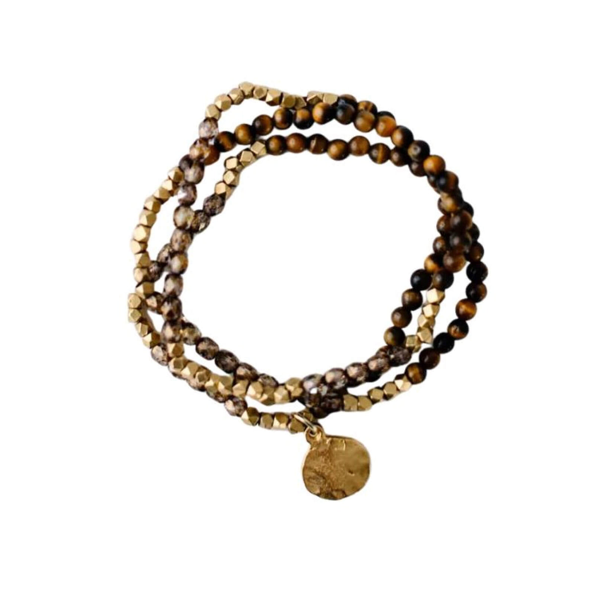 Stack of brown and gold beaded bracelets with a gold charm on a white background