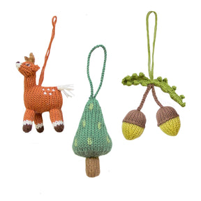 Knitted deer, acorn, and leaf ornament set on a white background