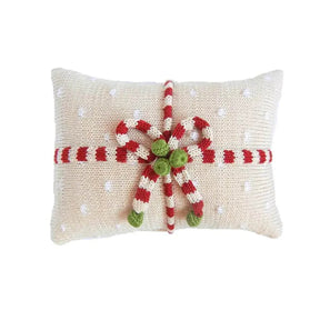 Decorative pillow with candy cane bow tie on a white background