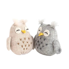 Two knitted owl toys, one beige and one gray, on a white background