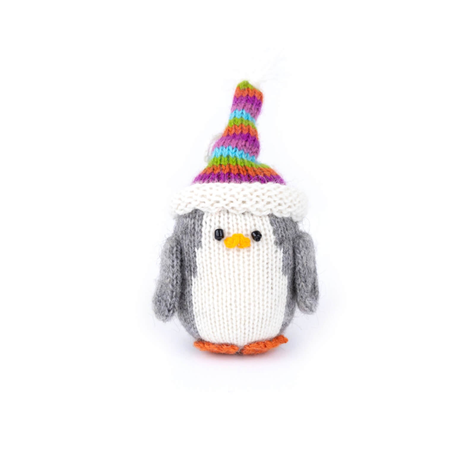 Knitted penguin toy with a colorful striped hat on a white background