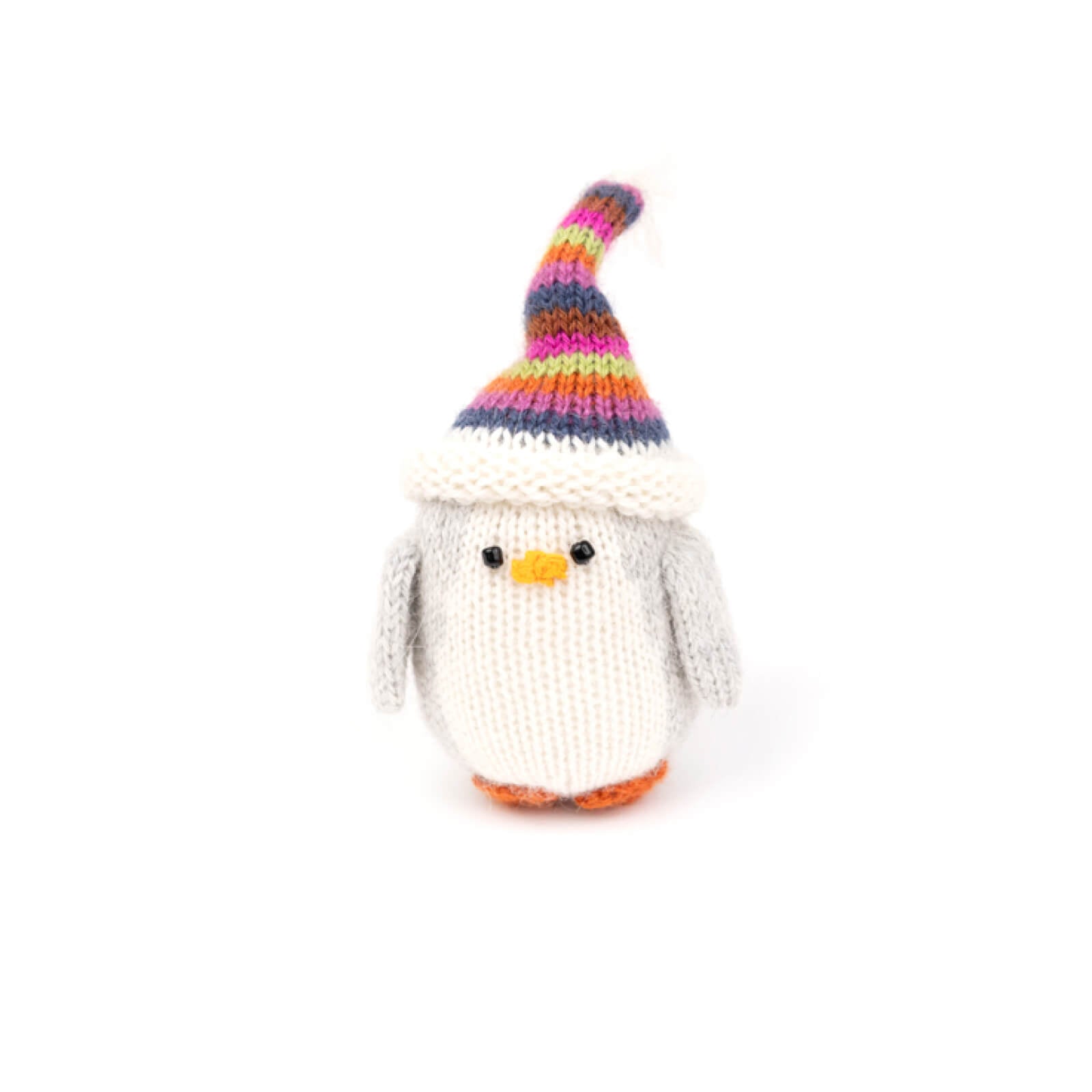Knitted penguin with a colorful striped hat on a white background