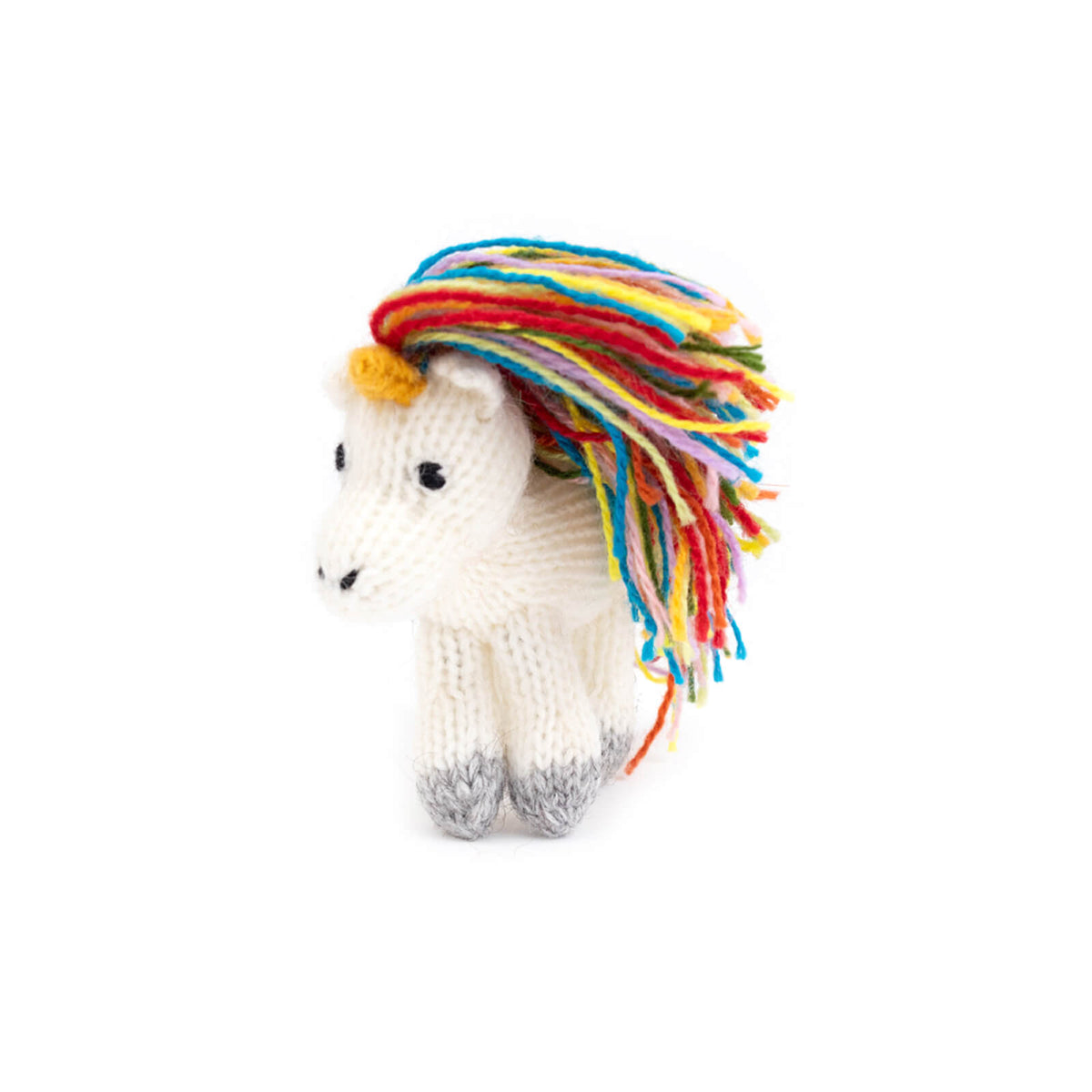 Knitted unicorn toy with colorful mane on a white background