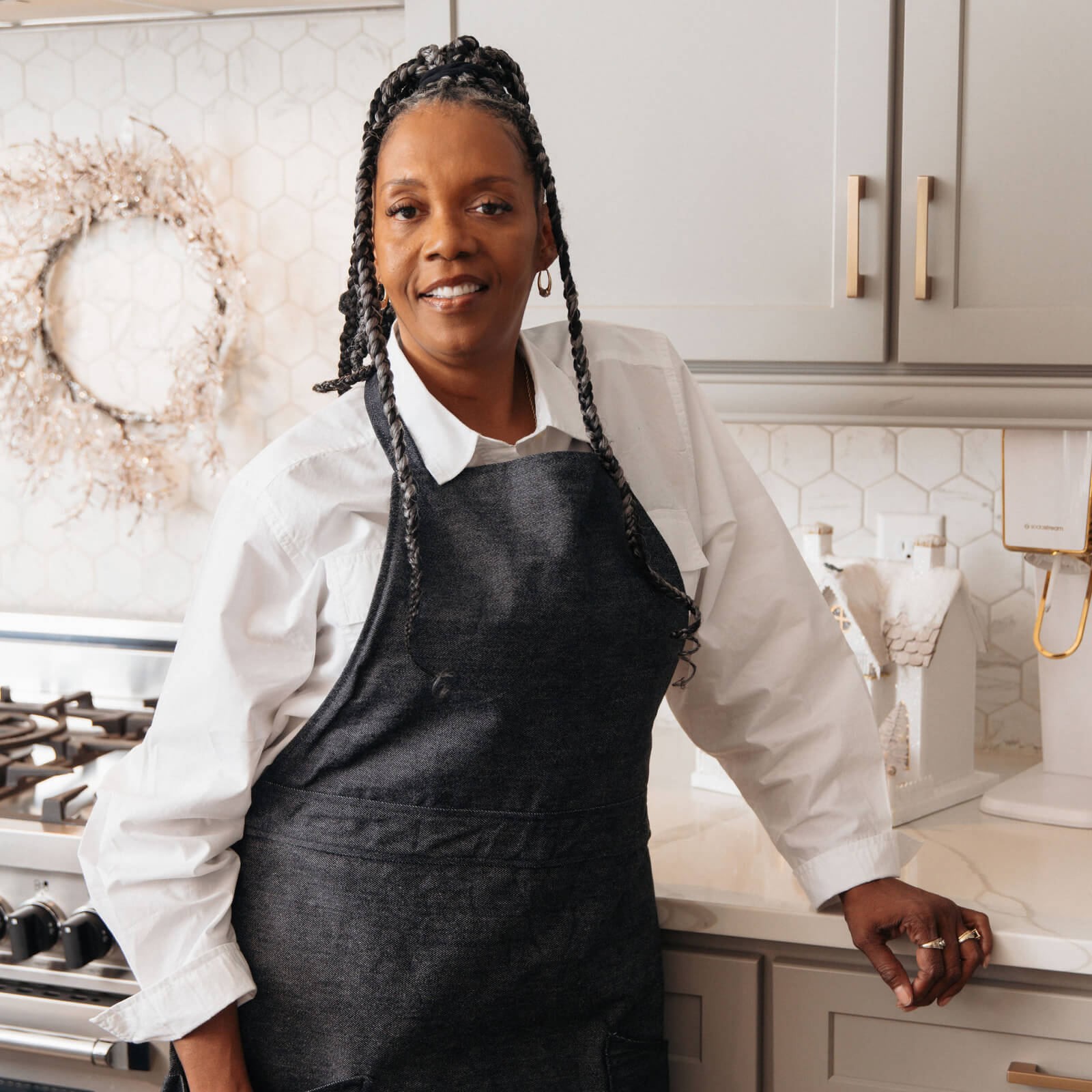 Person wearing a black apron in a kitchen setting