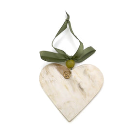 Heart-shaped marble ornament with a green ribbon on a white background