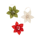Three floral ornaments in green, red, and beige on a white background