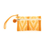 Orange and white patterned wristlet with a gold zipper on a white background