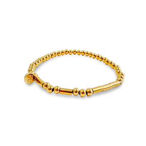Gold beaded bracelet on a white background