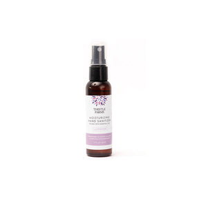 Thistle Farms moisturizing lavender hand sanitizer bottle, shown on a white background.