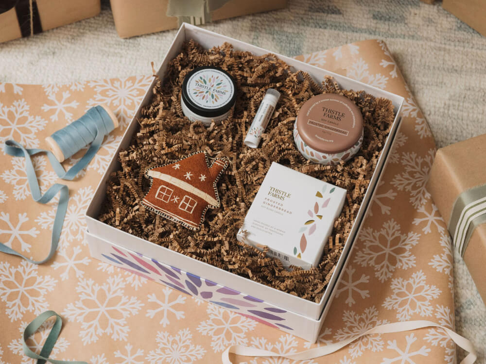 Gift box with decorative items on a patterned surface