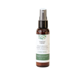 Thistle Farms moisturizing hand sanitizer bottle on a white background