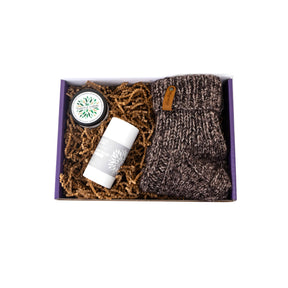 Set of items including a jar, a bottle, and a knitted item in a box on a white background