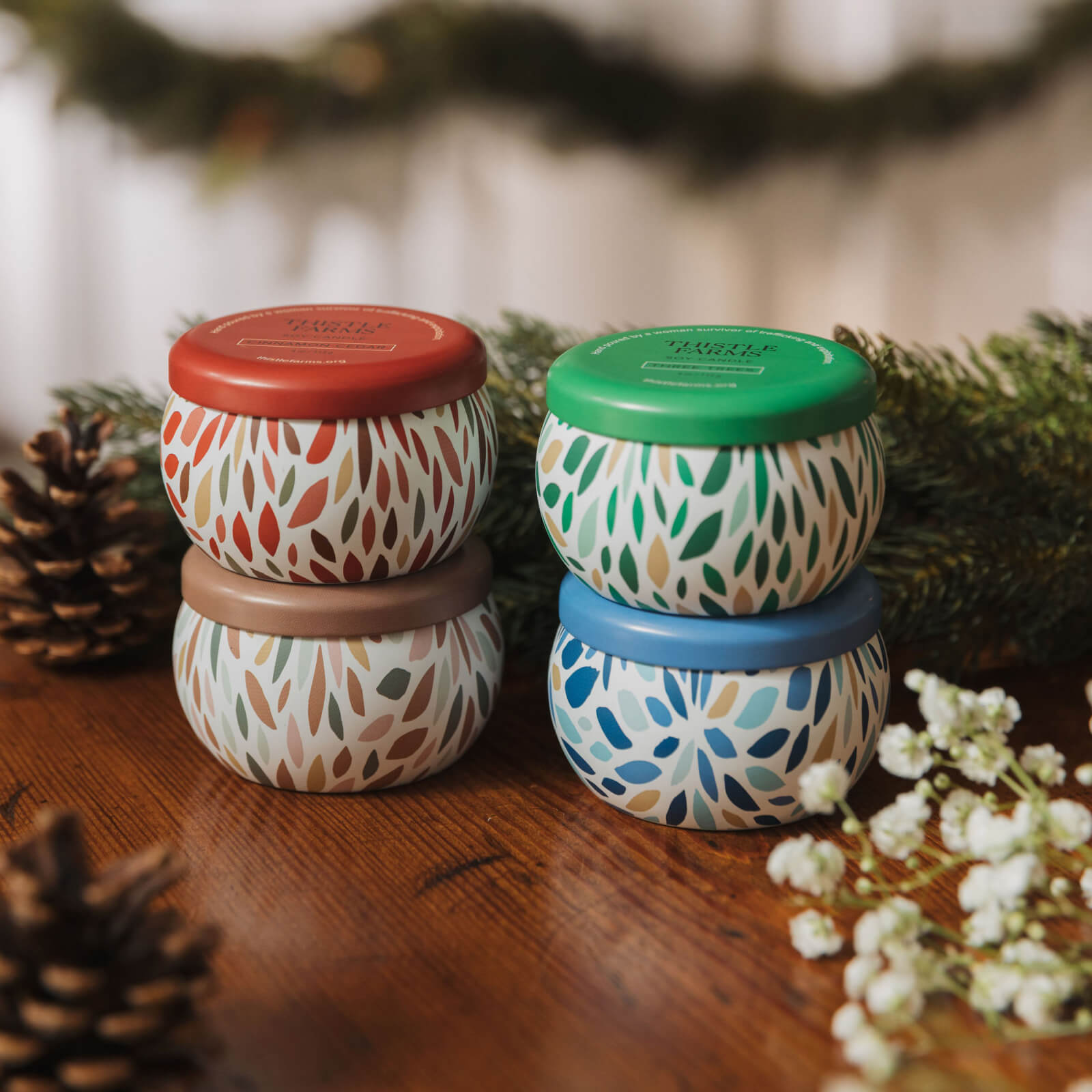 Set of patterned jars with colorful lids on a wooden surface with decorative elements.