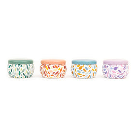 Four small containers with colorful patterns and lids on a white background