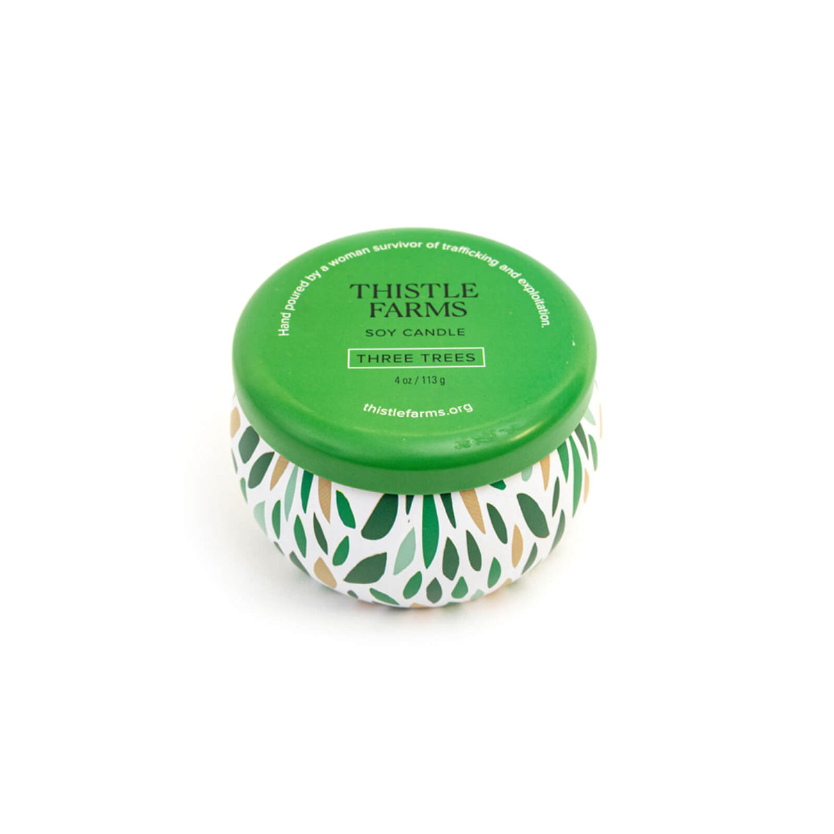 Thistle Farms candle with green lid and leaf pattern on a white background
