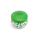 Thistle Farms candle with green lid and leaf pattern on a white background