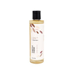 A bottle of Thistle Farms Naturals Vanilla Bean Body Wash with a black cap and a cream-colored label decorated with brown leaf illustrations, set against a plain white background.