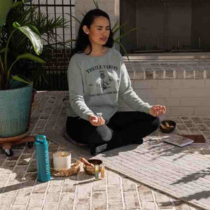 Woman meditating with candle, mat