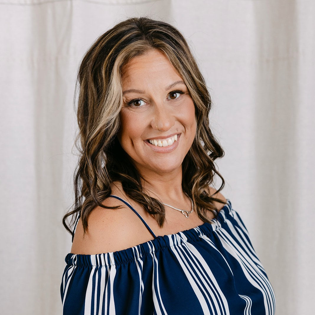 woman wearing a striped shirt smiling